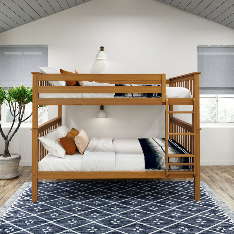Wooden bunk bed with white and orange pillows in a modern bedroom with a patterned blue rug and natural lighting.