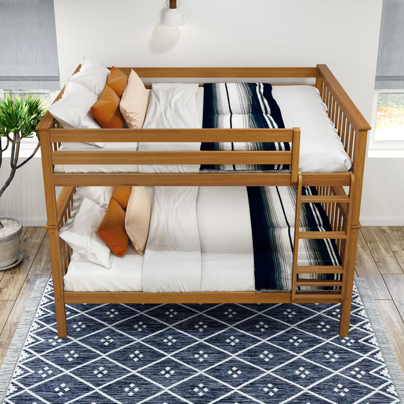 Wooden bunk bed with pillows and blankets on a geometric patterned rug in a bright room.