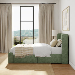 Elegant bedroom with green upholstered bed, large window view of outdoors, beige curtains, and modern decor.