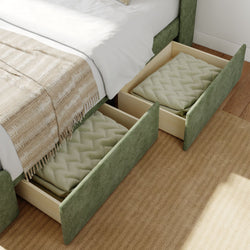 Under-bed storage drawers with green upholstery, featuring cozy blankets, in a modern bedroom setting.