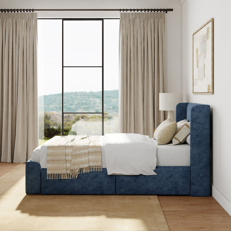 Modern bedroom with blue upholstered bed, large window view, and elegant beige curtains.