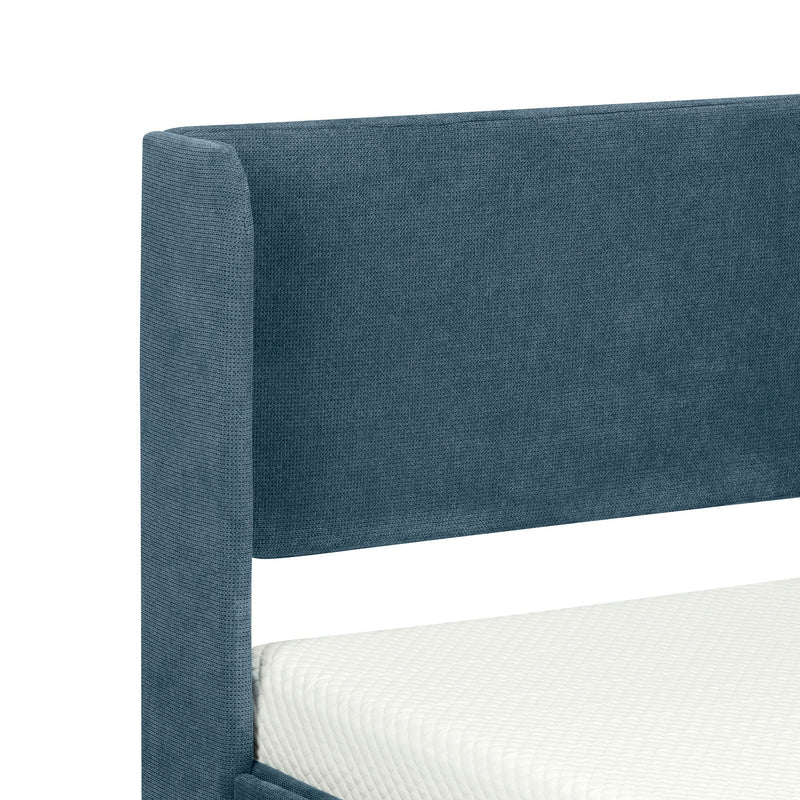 Blue upholstered headboard on modern bed frame with white mattress.