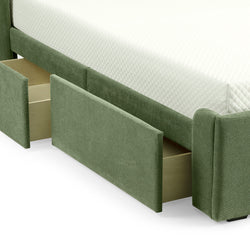 Green upholstered bed with open storage drawers beneath a white quilted mattress.