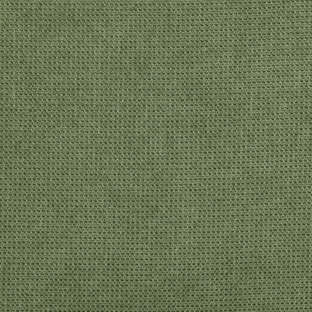 Green textured fabric background with waffle weave pattern.
