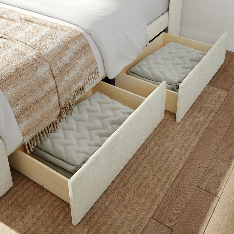 Underbed storage drawers with folded blankets on a wooden floor.