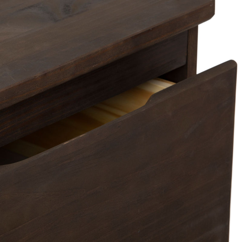 Open dark wood drawer of a modern dresser showing detailed craftsmanship.