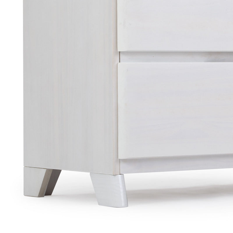Close-up of a modern white wooden dresser with angled legs and sleek drawer design.