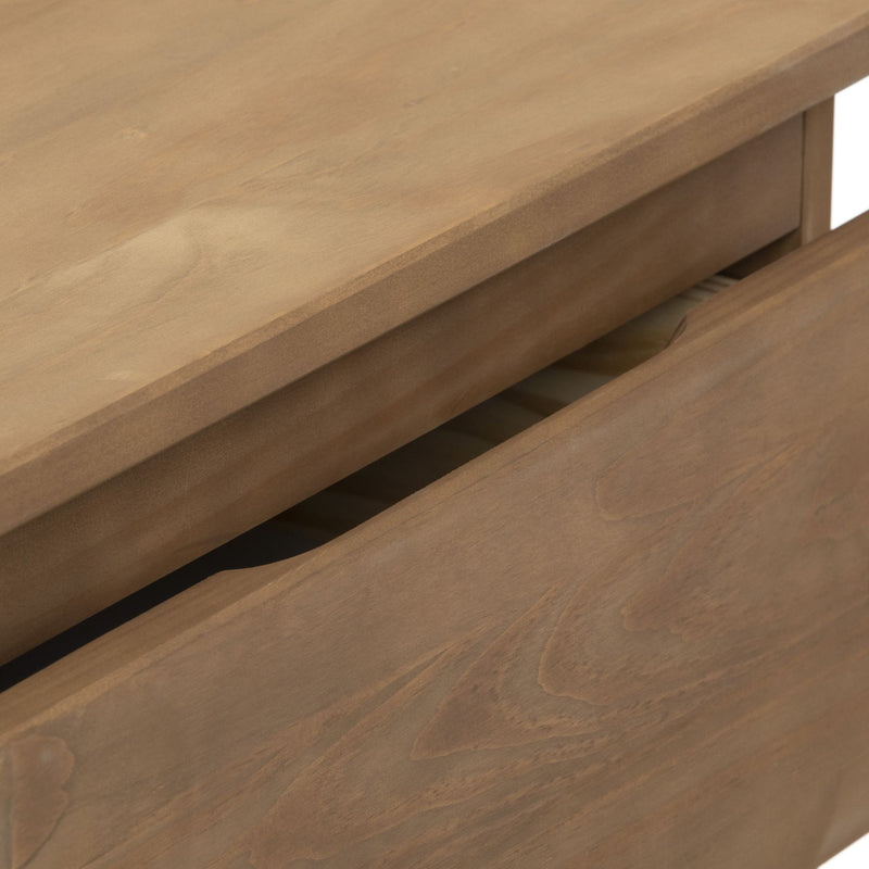 Close-up of a wooden dresser with an open drawer, showcasing natural wood grain texture.