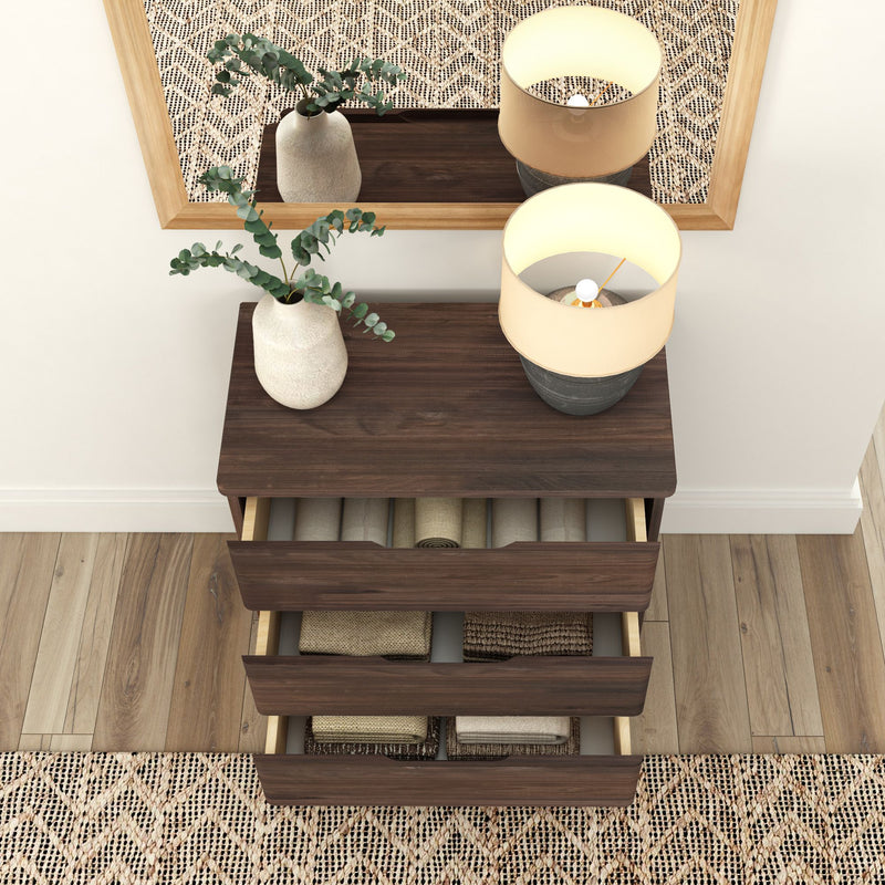 Wooden dresser with open drawers, potted plant, and lamp, placed on a patterned rug in a modern living room.