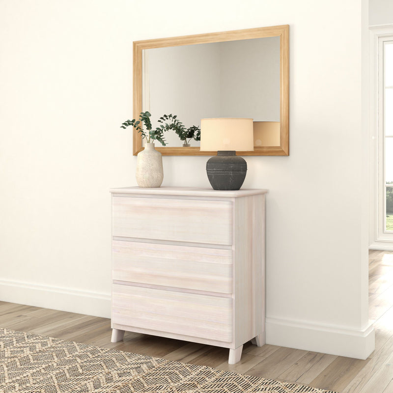 Modern white dresser with decorative mirror, lamp, and vases in a stylish bedroom setting.