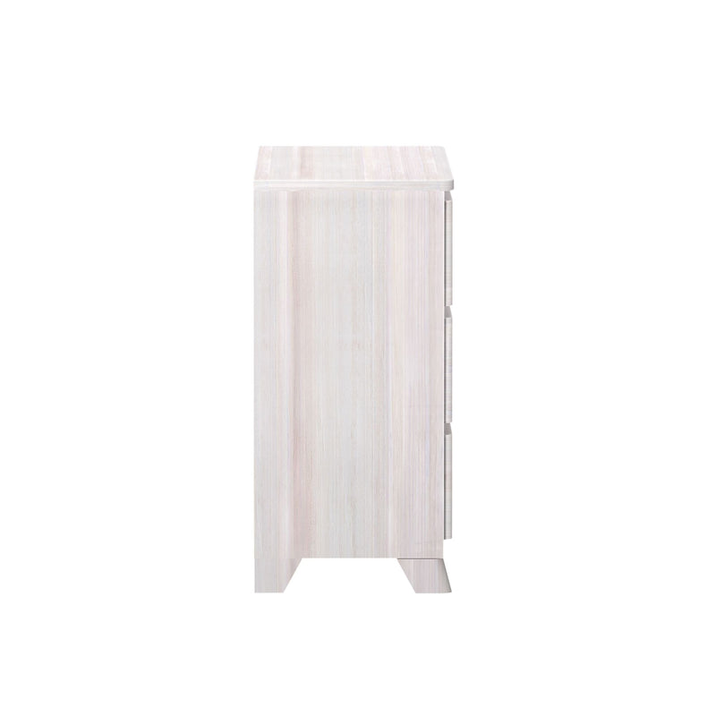 Side view of a modern whitewashed wooden dresser with three drawers for bedroom storage.