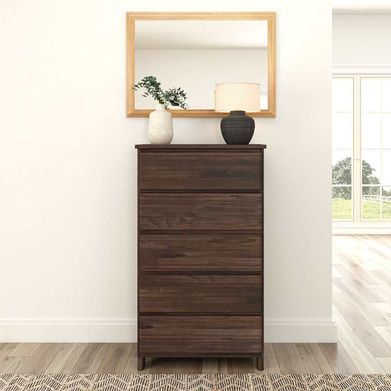 Tall wooden dresser with decorative vases and lamp, positioned in front of a large mirror in a modern minimalist living room.