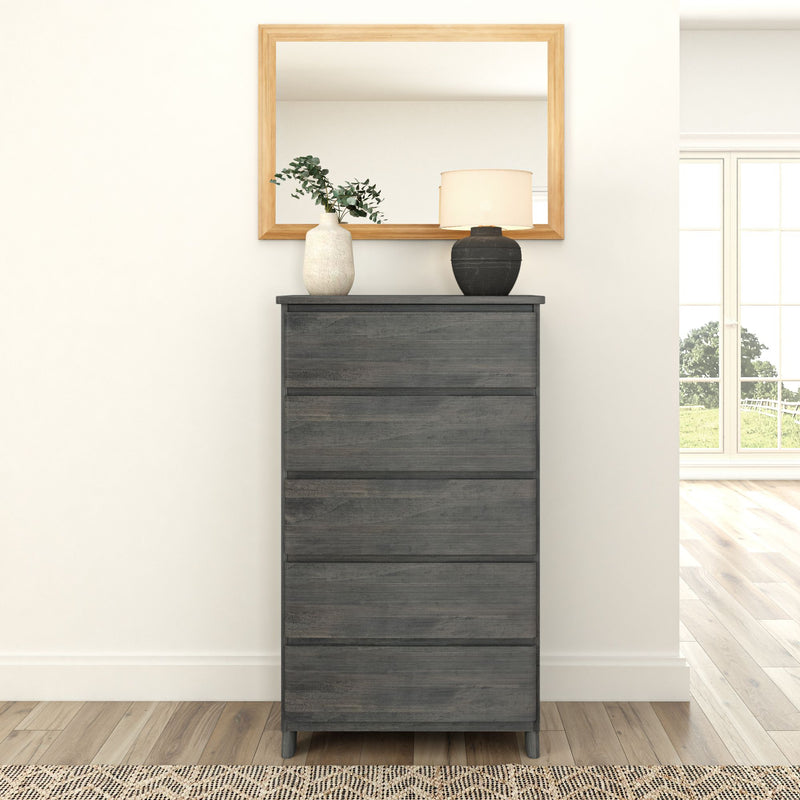 Dark wood dresser with decorative vases and lamp, framed mirror on white wall, modern minimalist bedroom design.