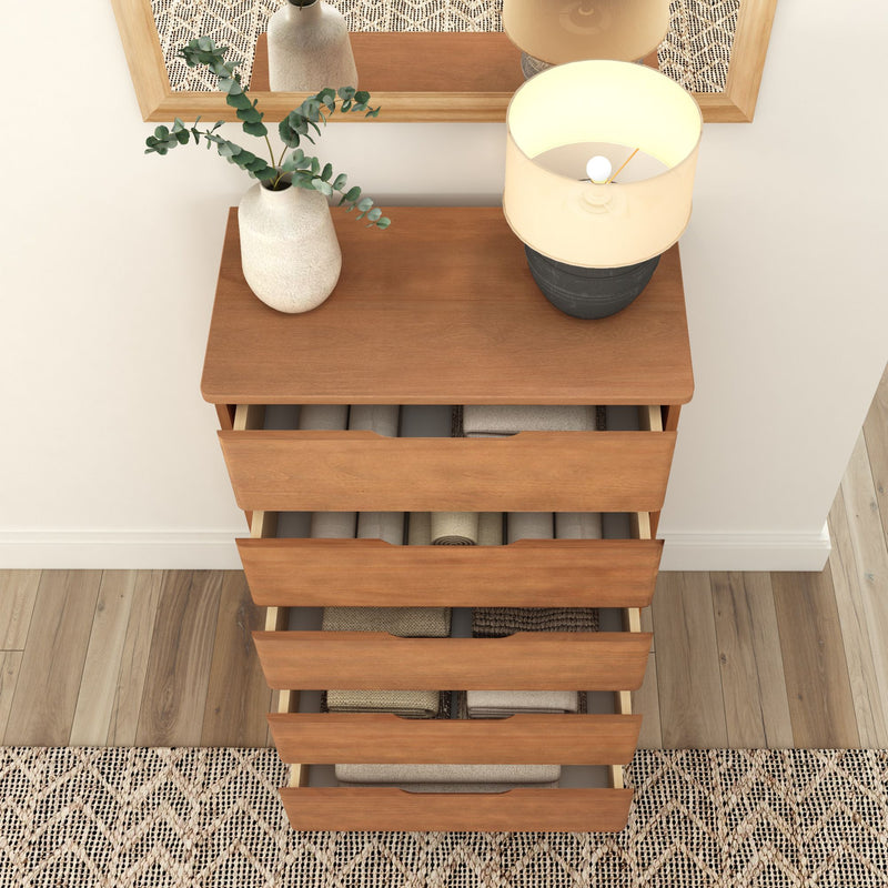 Top view of a modern wooden dresser with open drawers, decorated with a table lamp and a vase with greenery, perfect for bedroom organization.