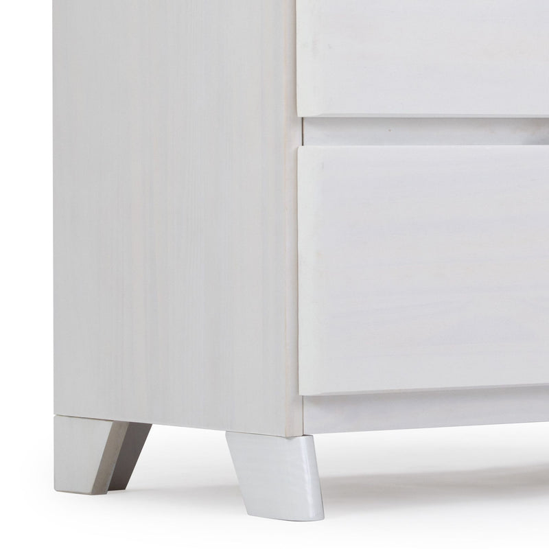 Modern white wooden dresser corner with sleek leg design.