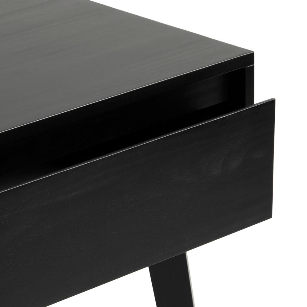 Close-up view of modern black wooden table corner with sleek design.