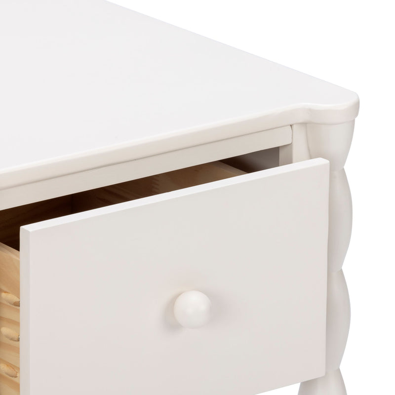 White wooden nightstand with open drawer and round knob, close-up of farmhouse-style bedside table