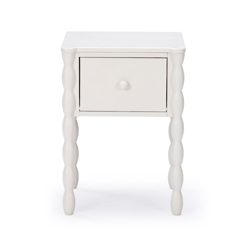 White wooden nightstand with spindle-turned legs and single drawer — farmhouse-style bedside table