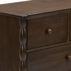 Close-up of dark brown solid wood dresser drawers with round wooden knobs and carved turned column detail, traditional bedroom furniture finish