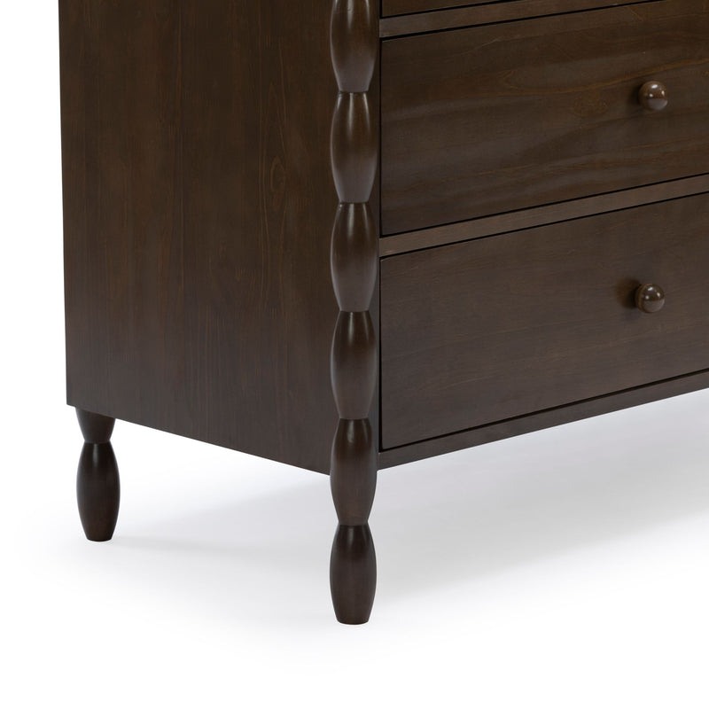 Close-up of dark brown solid wood dresser corner with turned spindle legs and two drawers, modern farmhouse bedroom furniture detail