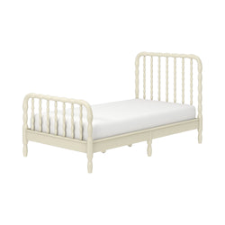 Cream wooden spindle bed frame with turned headboard and footboard and white mattress, farmhouse-style vintage design