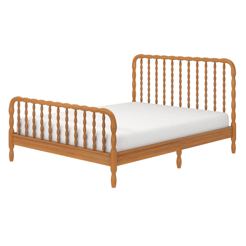 Natural wood spindle bed frame with matching headboard and footboard and white mattress on white background