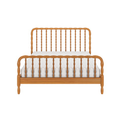 Front view of light oak wooden spindle bed frame with turned headboard and footboard and white mattress — farmhouse-style bedroom furniture