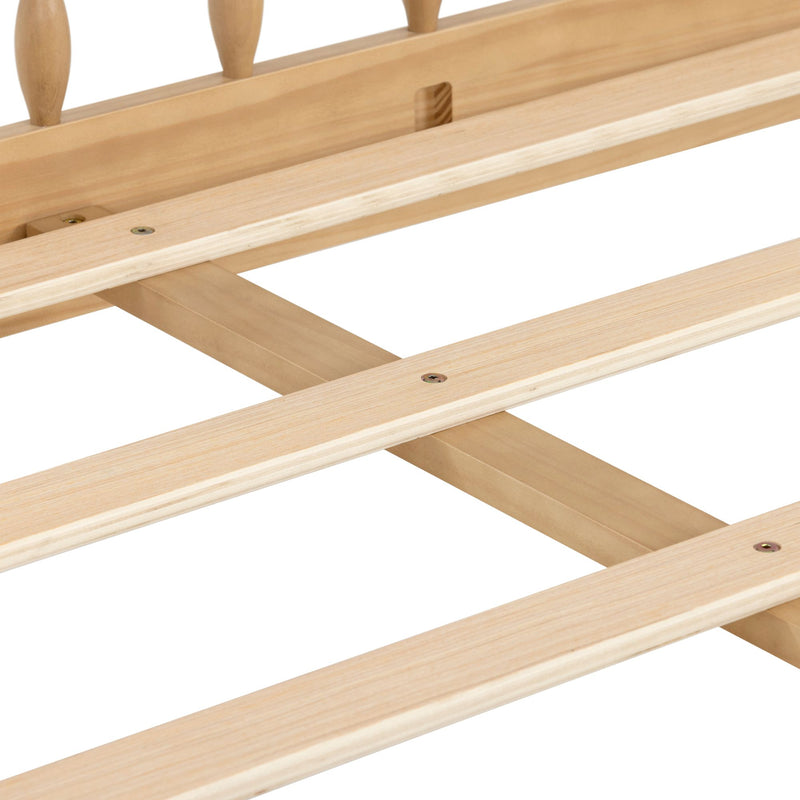 Close-up of light pine wooden bed slats with central cross support and recessed screws, mattress support system for a bed frame