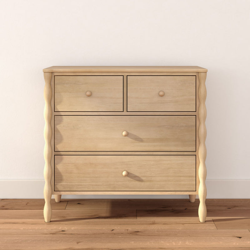 Light natural wood dresser with four drawers and turned legs on hardwood floor, minimalist Scandinavian chest for bedroom storage