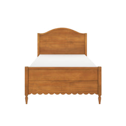 Twin-size wooden bed frame in warm oak finish with headboard and footboard, scalloped apron, turned legs and white mattress on a white background