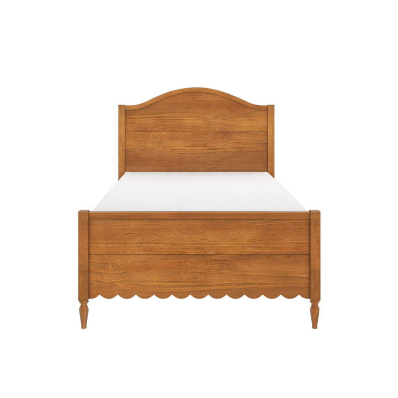 Twin-size wooden bed frame in warm oak finish with headboard and footboard, scalloped apron, turned legs and white mattress on a white background