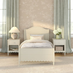 Cozy cream wooden bedroom with matching nightstands, ceramic table lamp, hydrangea vase, soft floral wallpaper and pale green curtains