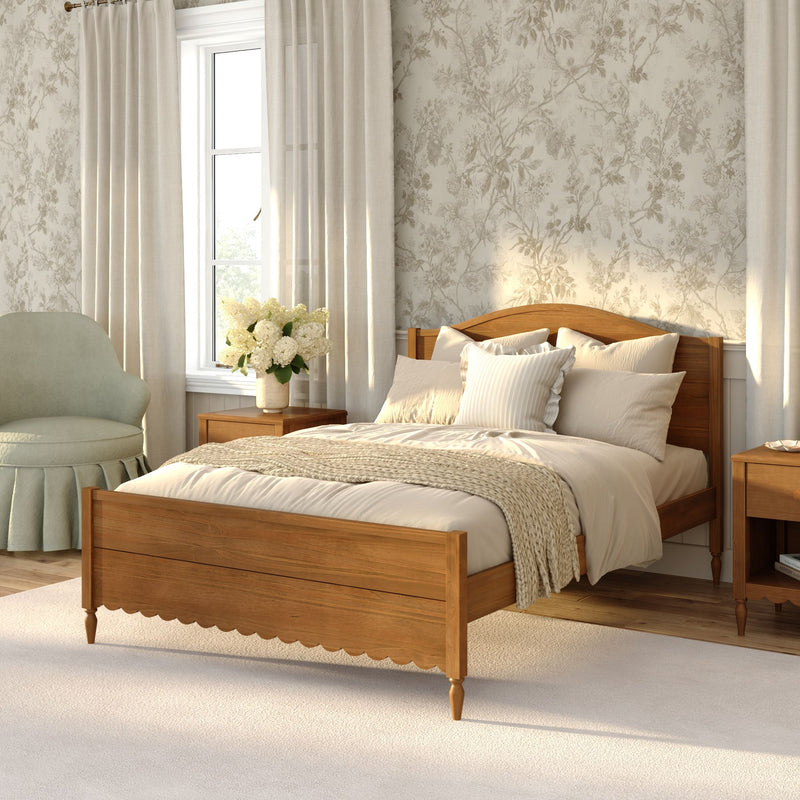 Cozy neutral bedroom with wooden bed, beige linens and knitted throw, floral wallpaper, wood nightstands and white hydrangea bouquet