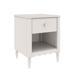 White wooden bedside table nightstand with single drawer, open lower shelf, turned legs and scalloped apron in farmhouse style