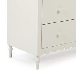 Close-up of white wooden bedside table nightstand with round knob drawers, turned legs and scalloped apron – bedroom furniture