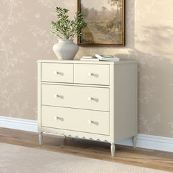 Cream vintage-style chest of drawers with a crackle ceramic vase of green branches, stacked books and framed landscape painting against beige floral wallpaper on hardwood floor