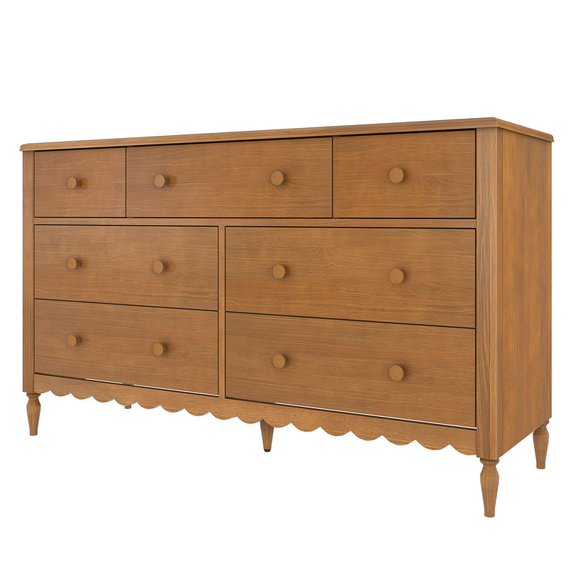 Oak-finish wooden dresser with multiple drawers, round wooden knobs, scalloped apron and turned legs — mid-century farmhouse bedroom storage chest