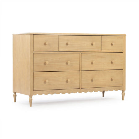 Light wood bedroom dresser with multiple drawers, round wooden knobs, turned legs and scalloped apron
