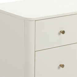 Close-up of white modern dresser drawer with rounded top edge and brass knob, minimalist bedroom nightstand detail