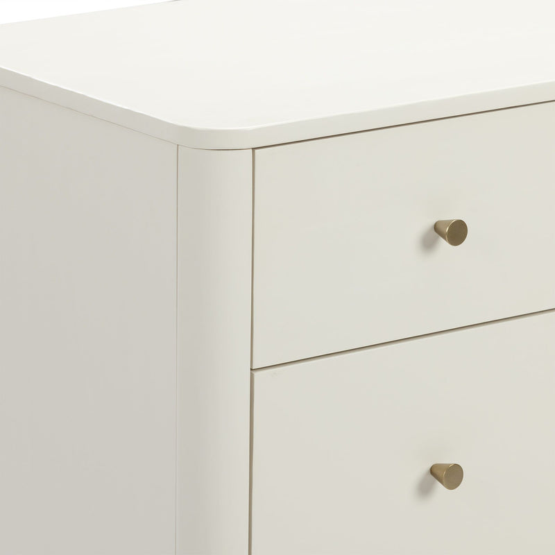 Close-up of white modern dresser drawer with rounded top edge and brass knob, minimalist bedroom nightstand detail