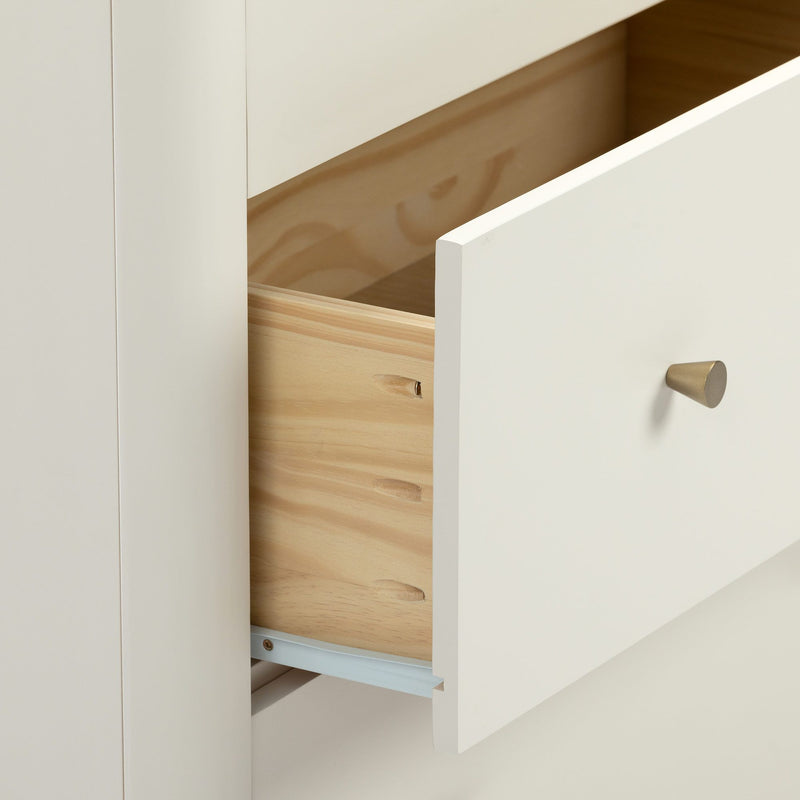 Minimalist white dresser drawer partially open revealing natural wood interior, brass cone knob and metal slide — modern bedroom storage detail