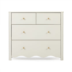 Cream four-drawer wooden dresser with round brass knobs and scalloped base for bedroom storage