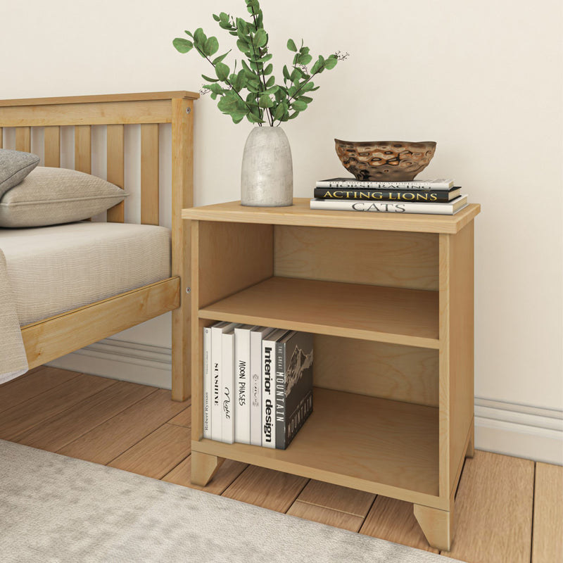 Wooden bedside table with books and a decorative vase in a modern bedroom setting.