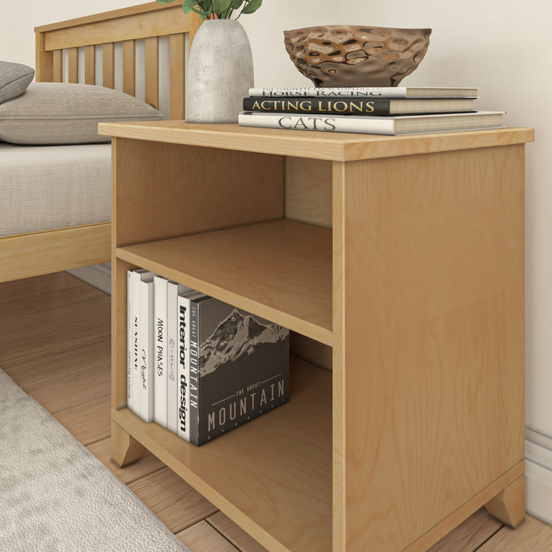 Wooden bedside table with books and a decorative bowl for modern bedroom decor.