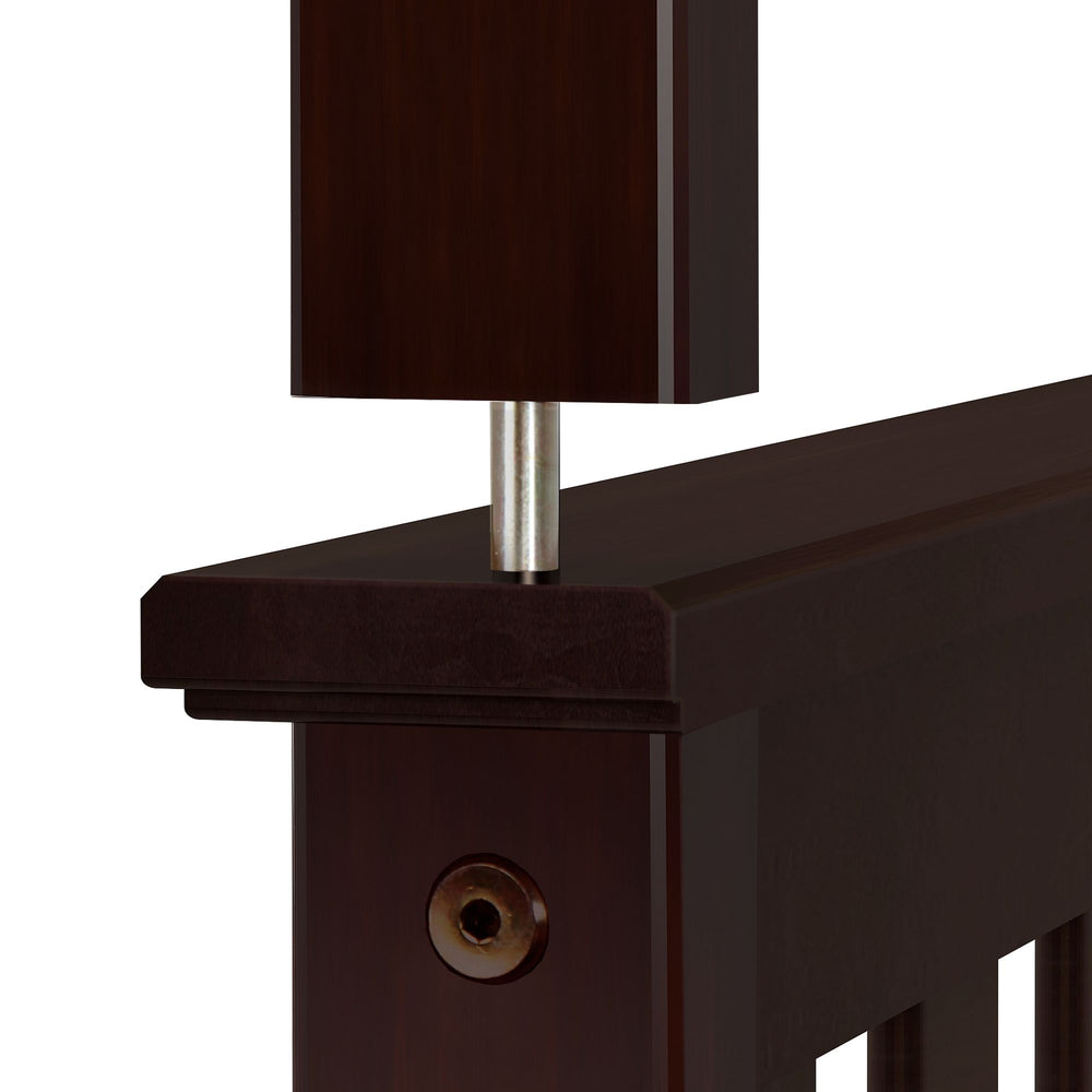 Close-up view of dark wood and metal bed frame joint for modern bedroom furniture design.