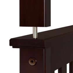 Close-up view of dark wood and metal bed frame joint for modern bedroom furniture design.