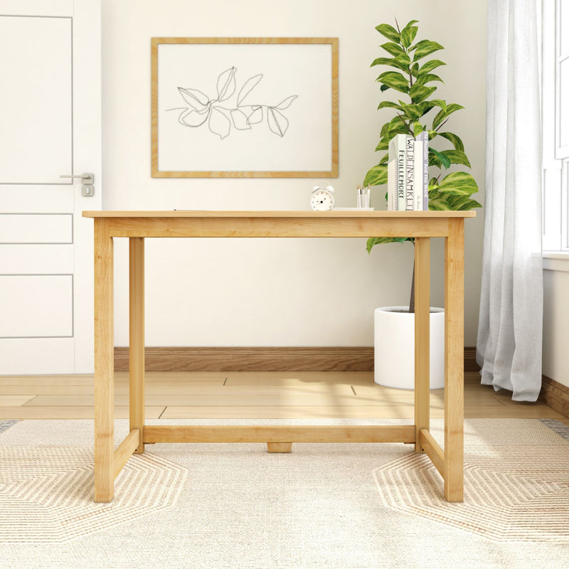 Modern minimalist home office setup with wooden desk, indoor plant, and decor books.