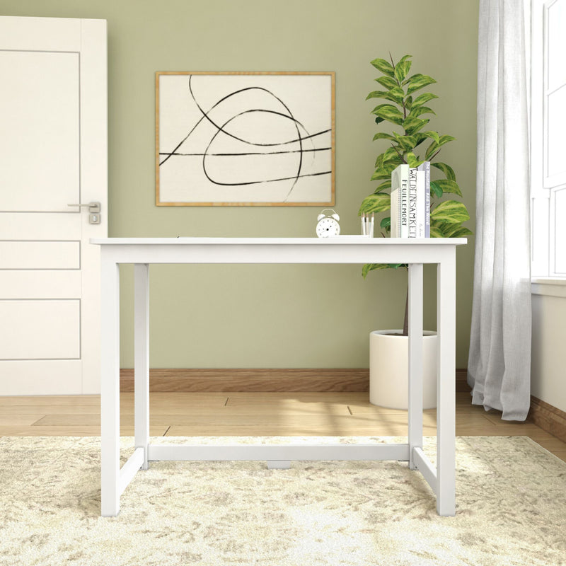 Minimalist white desk in modern home office with indoor plant and abstract wall art decor.