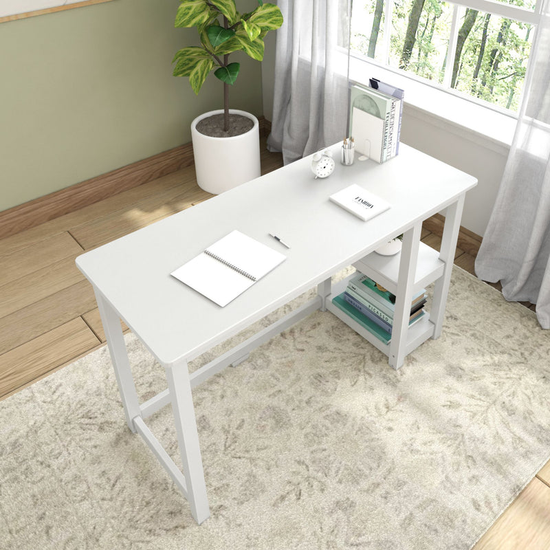 White modern writing desk with built-in open shelves in bright home office by window, minimalist small computer or study table on rug with potted plant