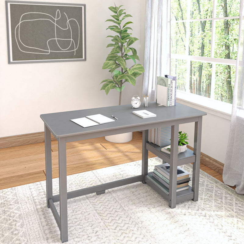 Modern gray home office desk with books and plant, ideal for remote work setup.